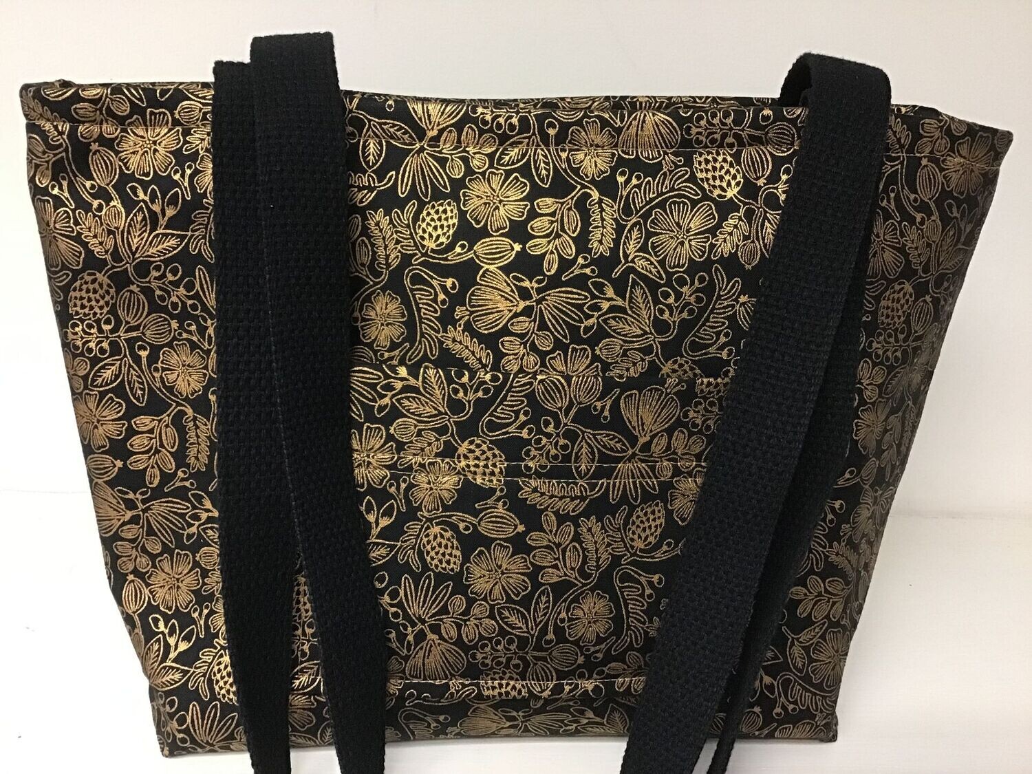 Small floral print in gold on black, black straps