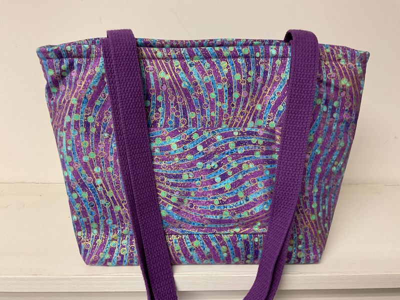 Swirling bubble print in purple, turquoise, and green with metallic gold, purple straps