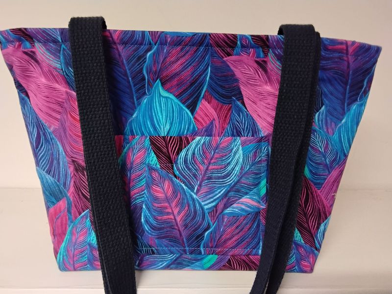 Large leaves in blues and pinks, dark blue straps