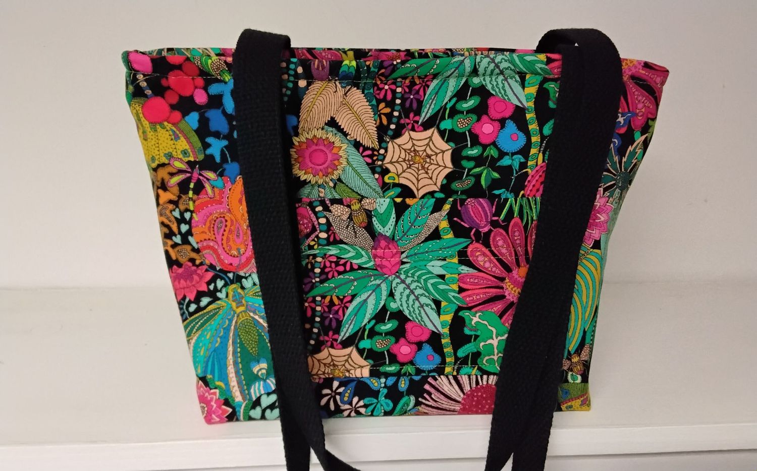 Bright garden flowers with bugs on black, black straps