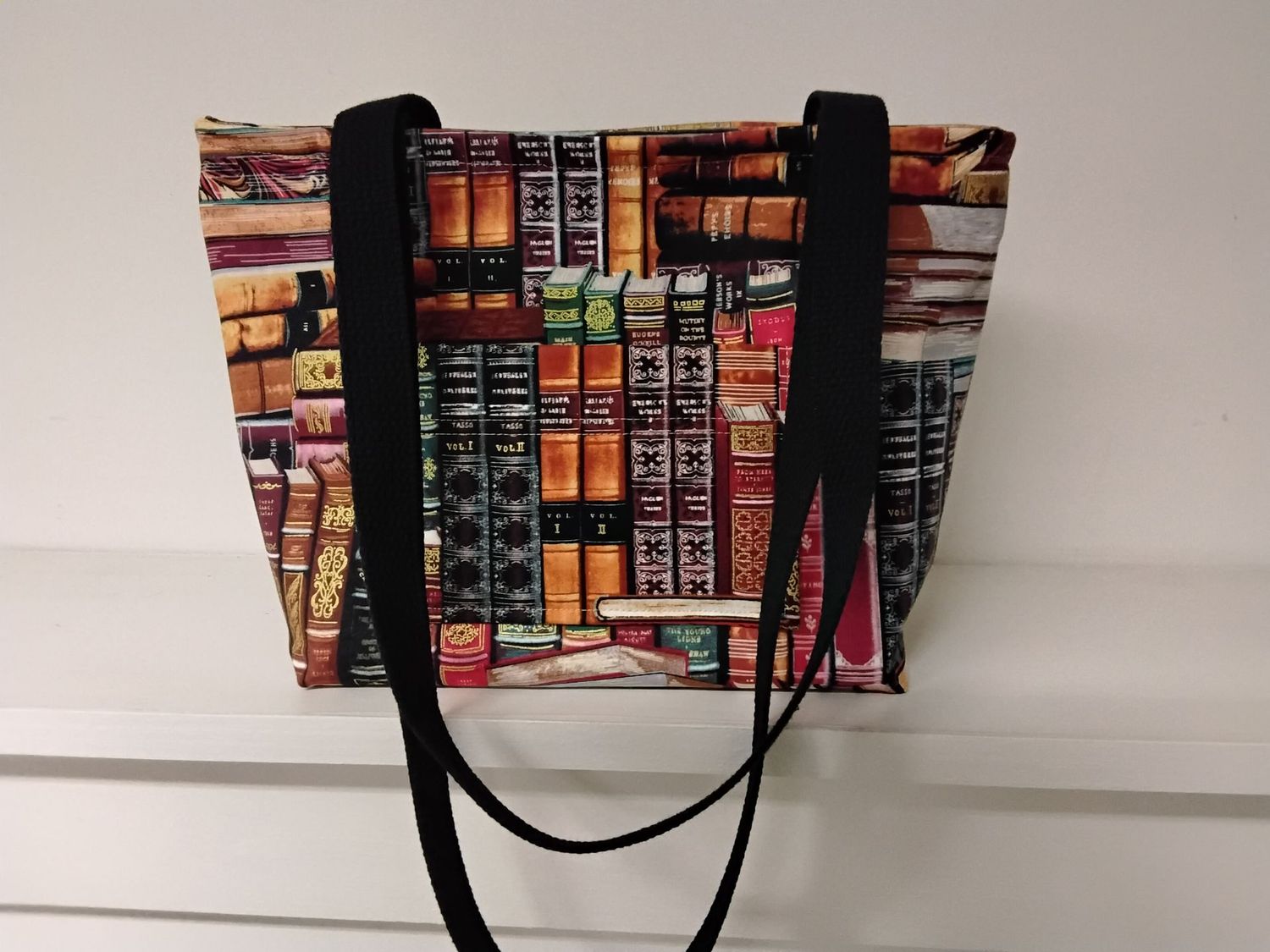 Stacks and rows of books, black straps