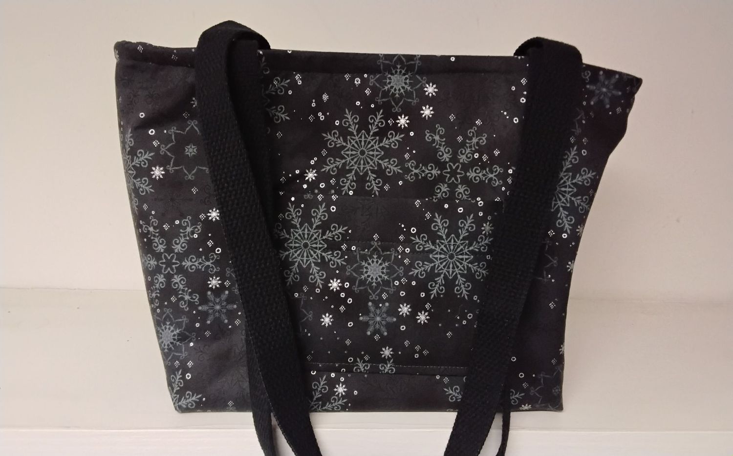 Snow sky with large snowflakes on black, black straps