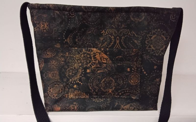 ORIGINAL SIZE bag in a black and brown geometric print with ONE LONG CROSS-BODY BLACK STRAP.  The adjustable strap measures 47.75" at maximum extension.