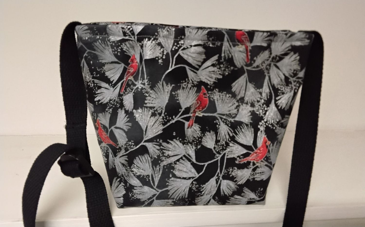 This SMALL SIZE bag is one size down from the original bag.  Red cardinals with silver leaves on black, with ONE LONG CROSS-BODY BLACK STRAP.  The adjustable strap measures 48" at maximum extension.