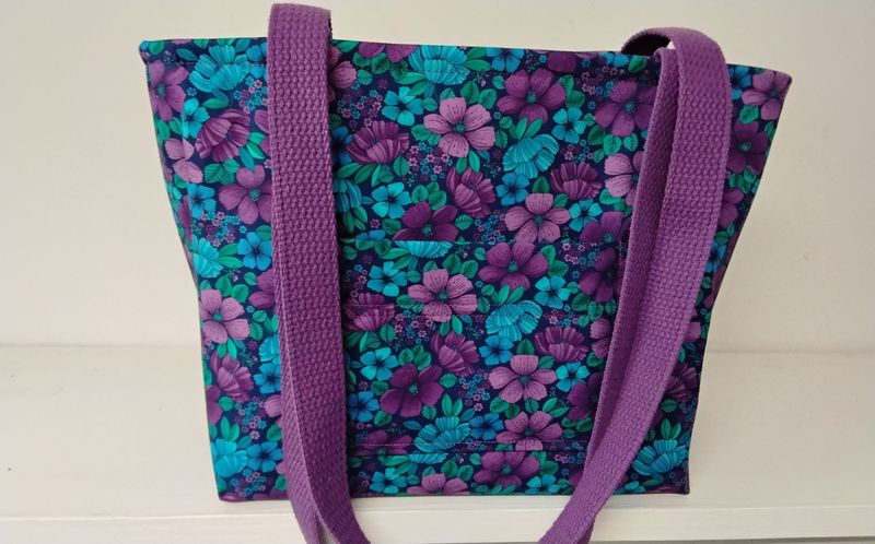 Floral print in blues and purple, purple straps Floral print in blues and purple, purple straps