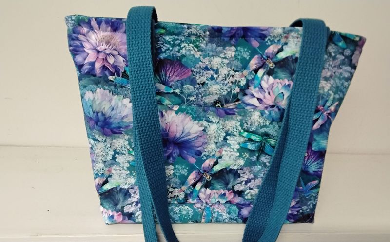 Multicolored print of flowers & dragonflies, medium blue straps Multicolored print of flowers & dragonflies, medium blue straps