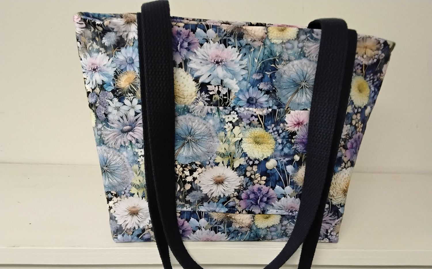 Dandelions and other garden flowers on black, black straps