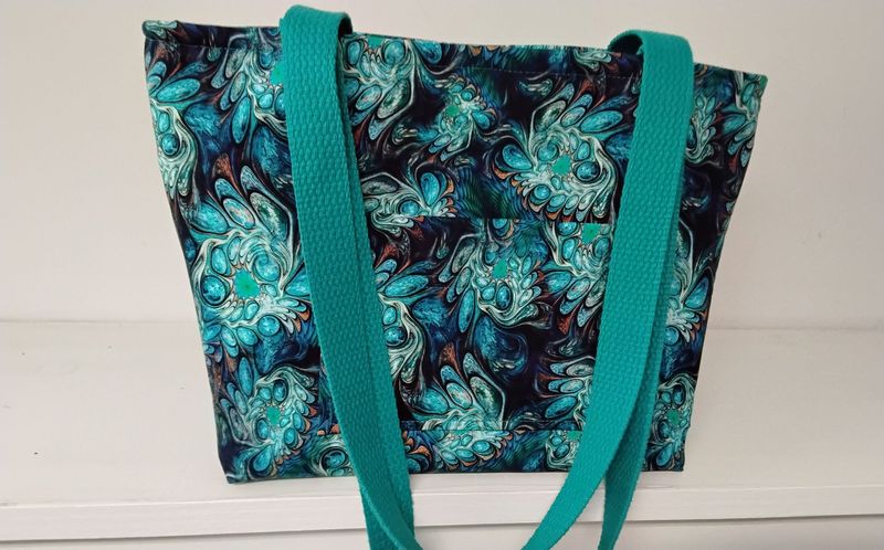 Teal green geometric design on black, teal straps Teal green geometric design on black, teal straps