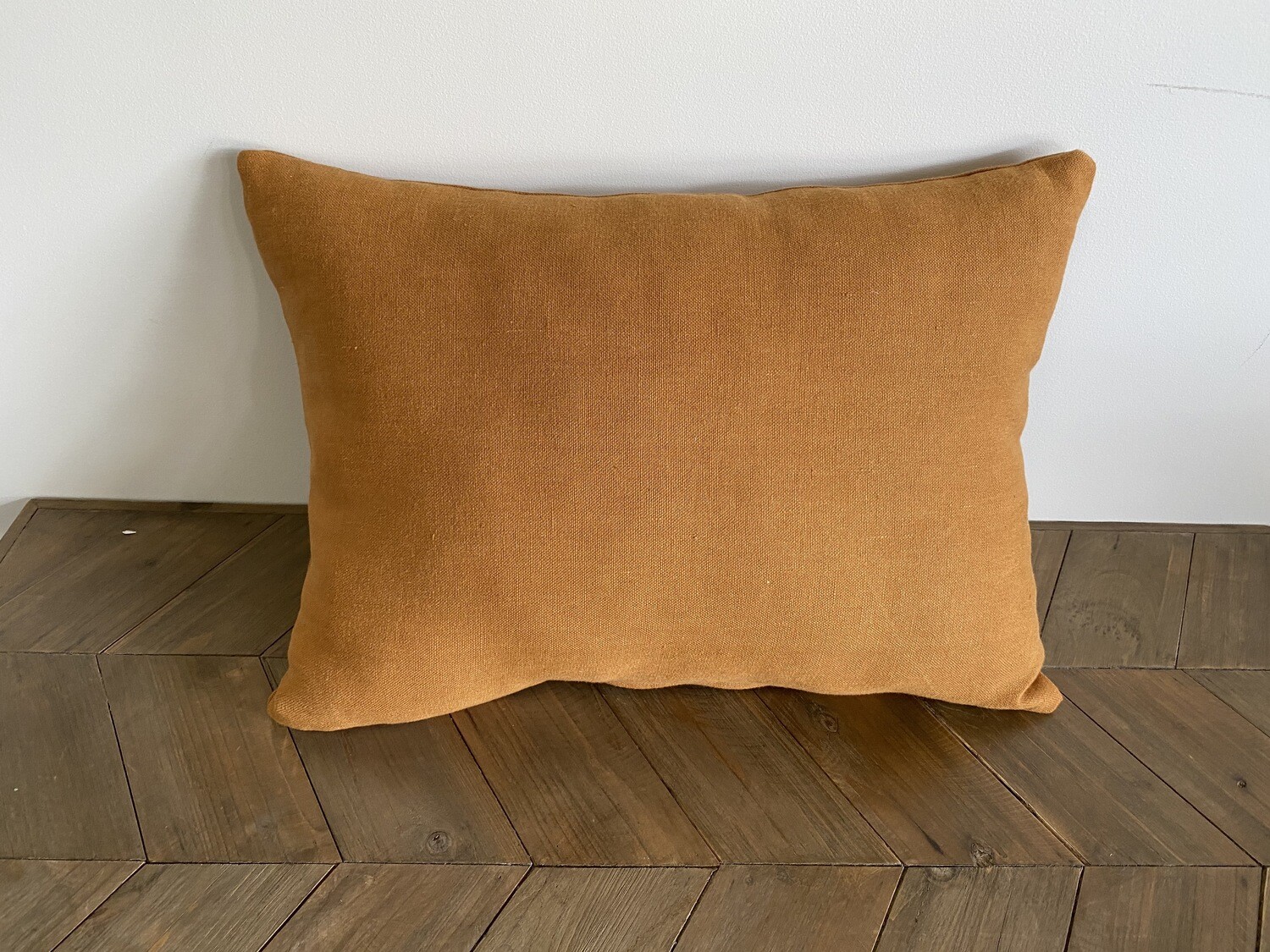 Rust coloured linen cushion
