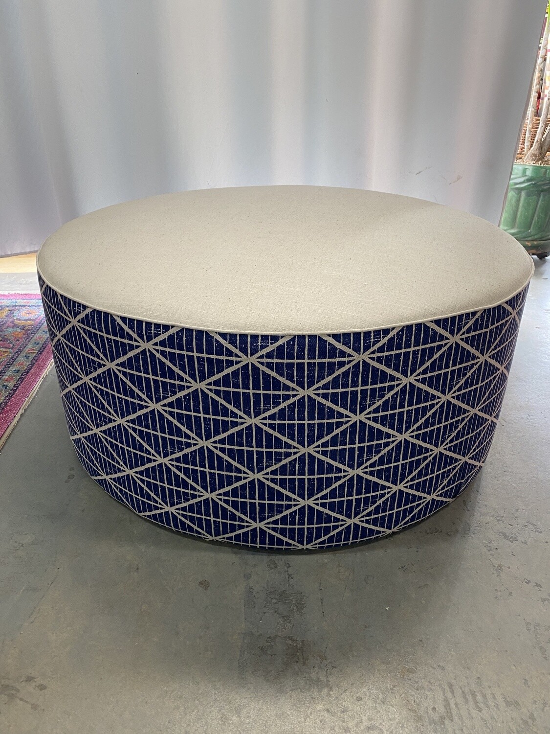 Large round ottoman with feather scatter cushion
