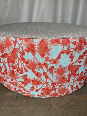 Large round ottoman with hand-screenprinted fabric and feather scatter cushion