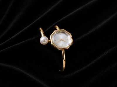 Golden tone Bangle watch.