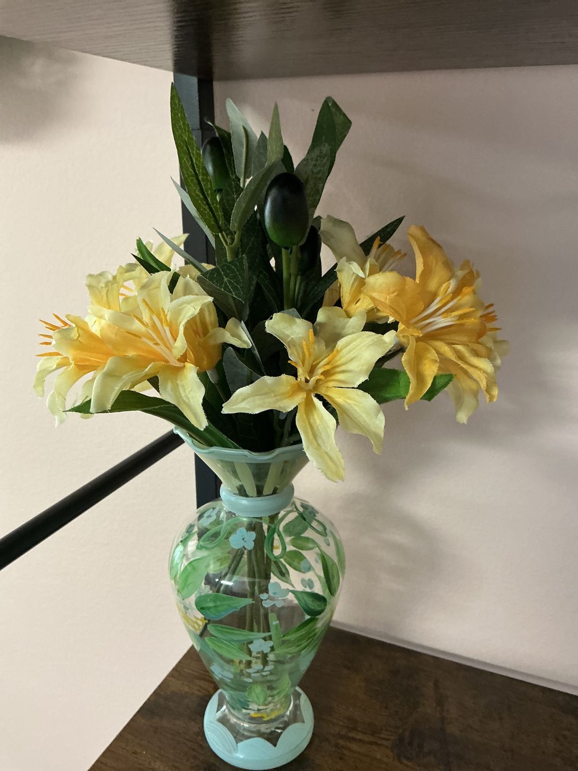 yellow flowers in blue and green hand painted vase