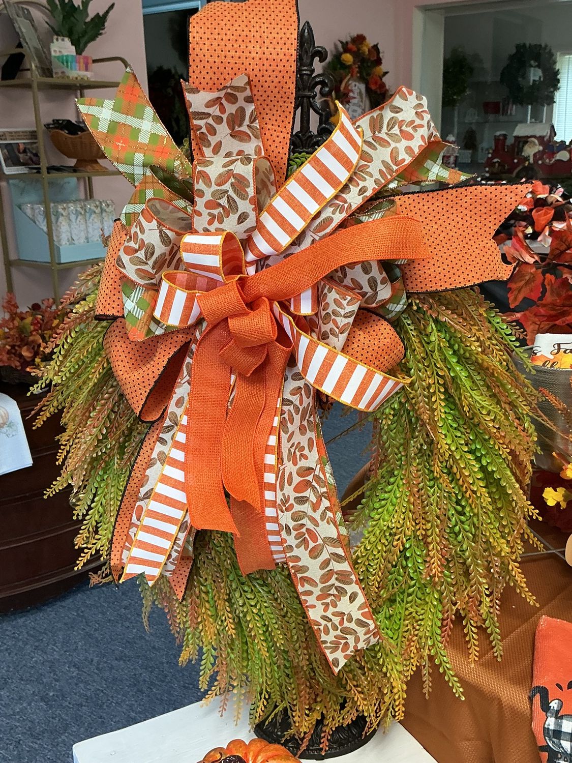 green and orange beaded wreath with bow