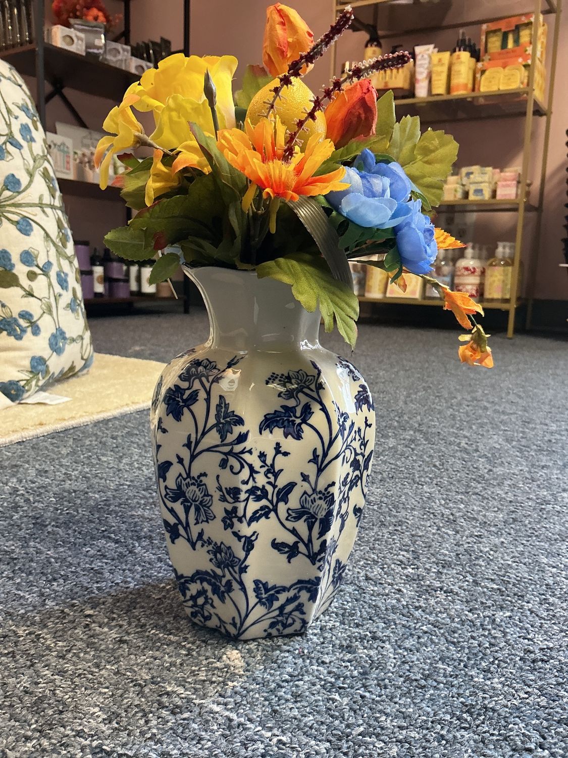 Yellow and blue flowers in blue vase