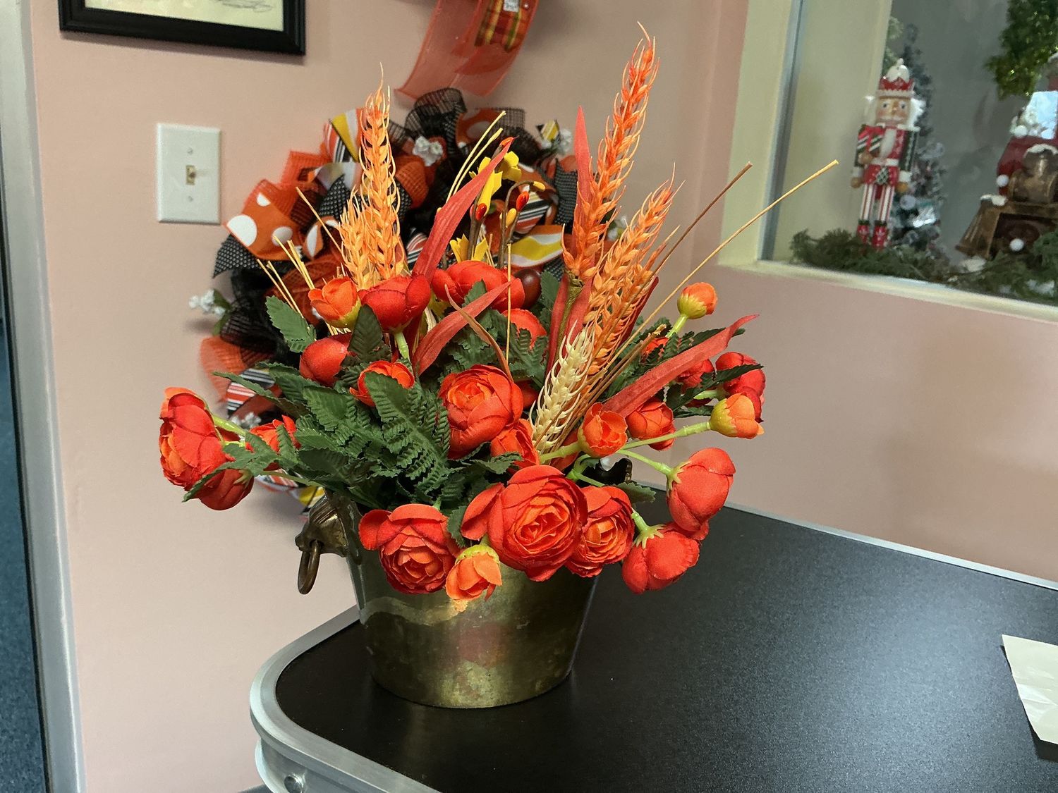 Metal container with orange miniature roses
