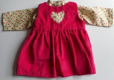 Outfit: Cerise pinafore with matching top for doll. 2 pieces.