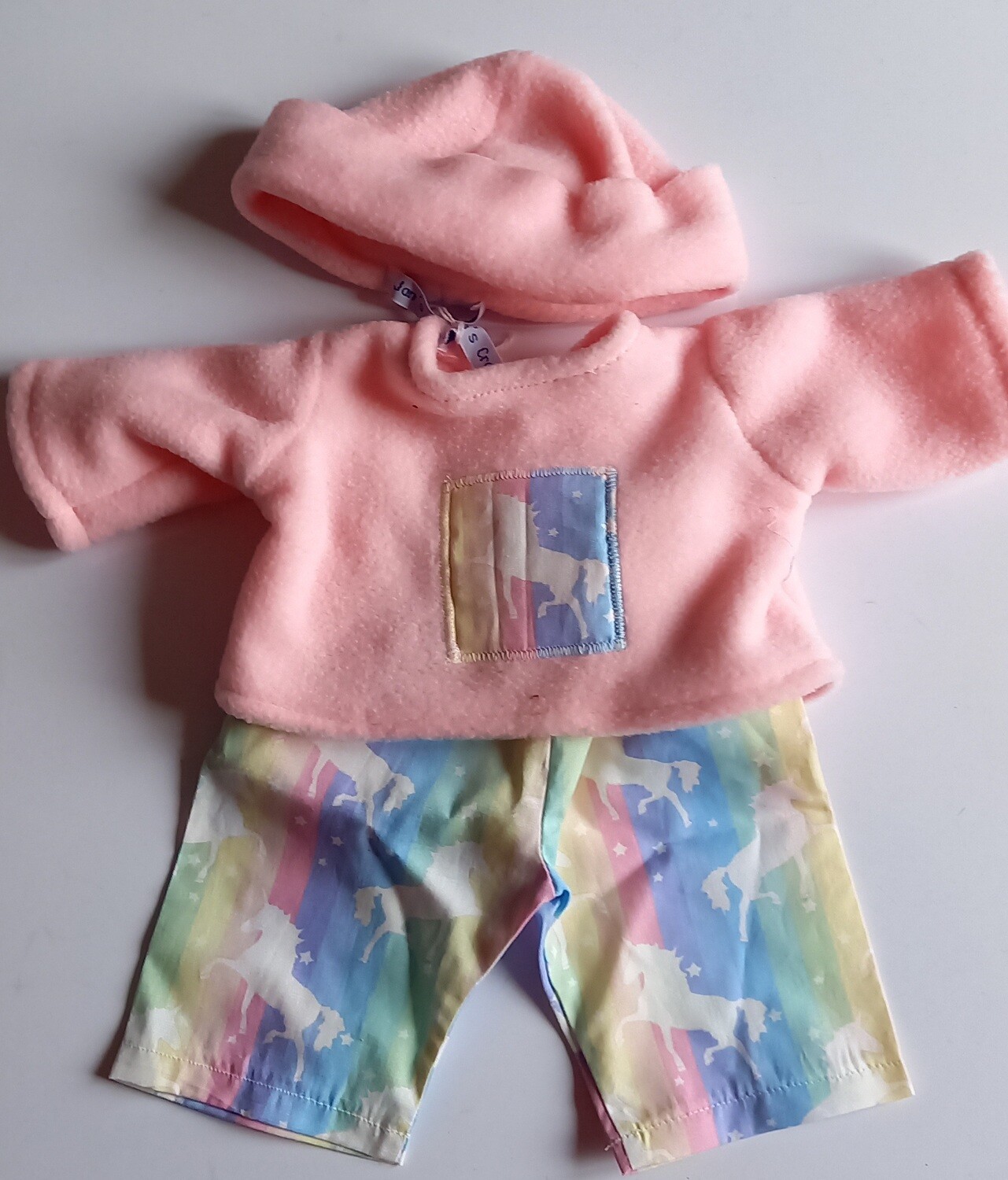 Outfit: Pink fleece top PJs with hat and unicorn print trousers for 36cm doll