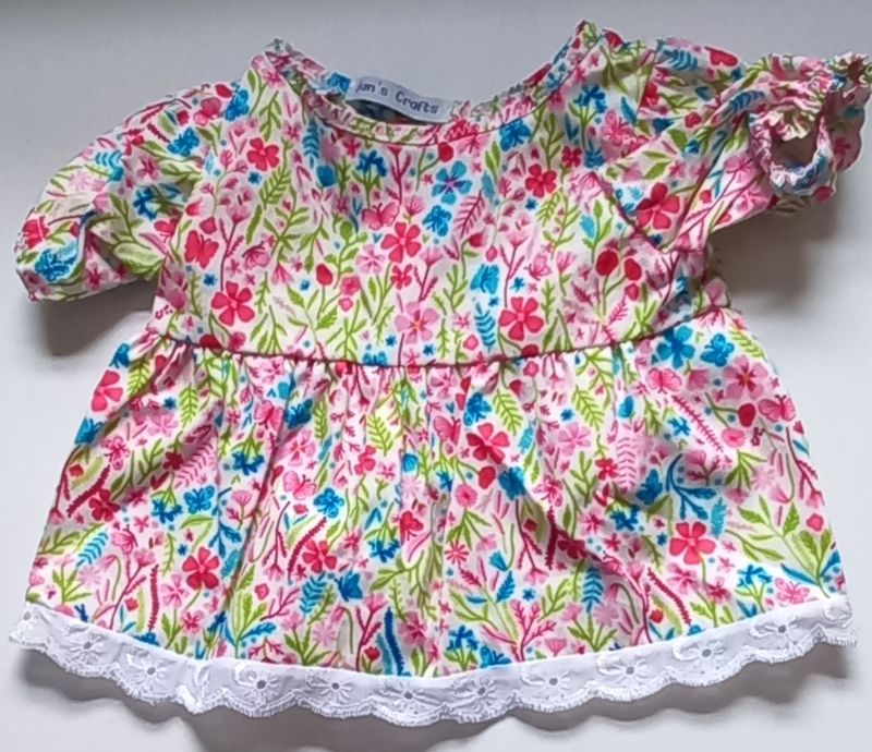 Dress: floral print and lace edged.