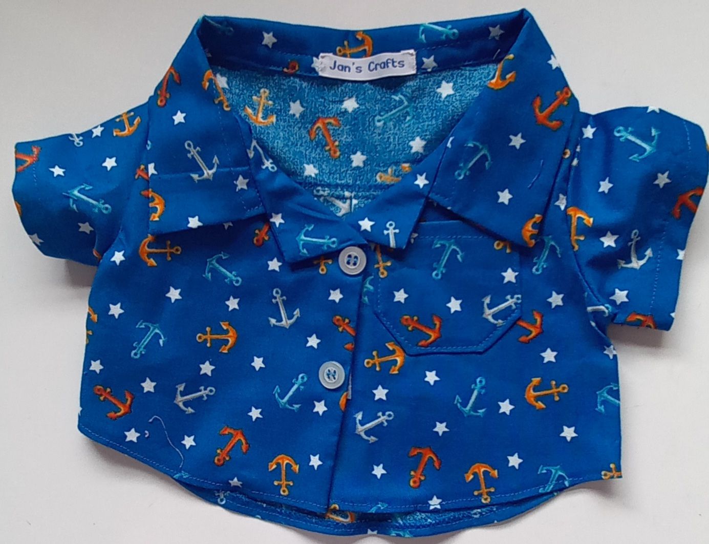 Shirt - anchor print on dark turquoise background.