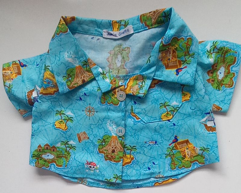 Shirt - pirate themed print on a turquoise background.