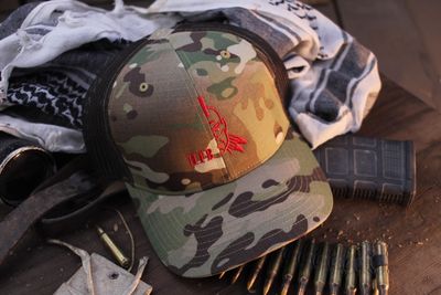 Half Face Blade Woodland Camo Trucker Cap