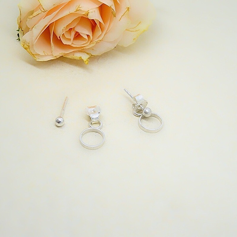 Silver stud earrings with circle behind the ear - Harry TiLLEY jewelry