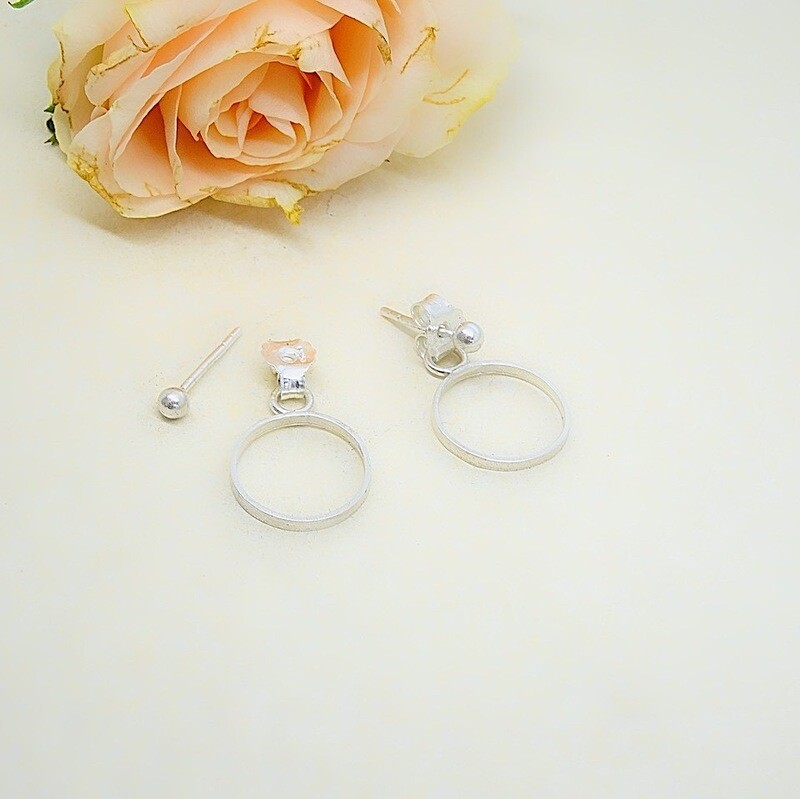 Silver stud earrings with circle behind the ear - Harry TiLLEY jewelry