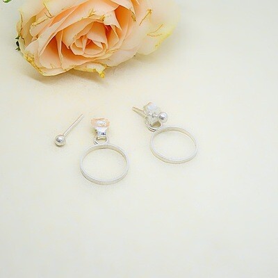 Silver stud earrings with circle behind the ear - Harry TiLLEY jewelry