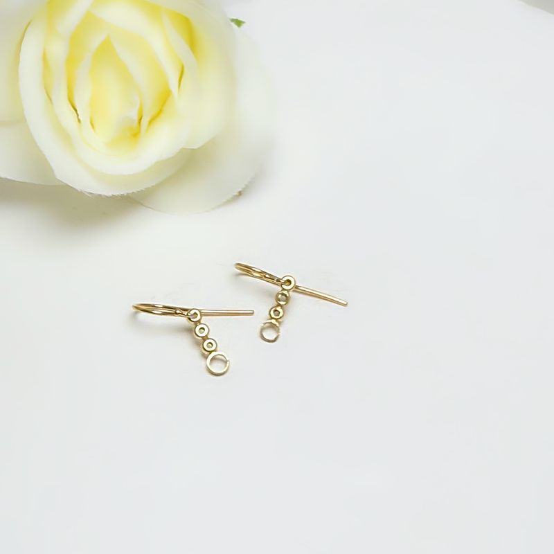 Gold-plated silver round earrings with balls and circles.