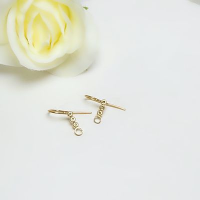 Gold-plated silver round earrings with balls and circles.