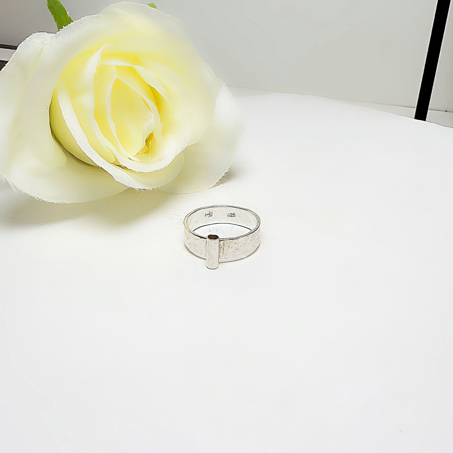 Silver ring with a tube at the front