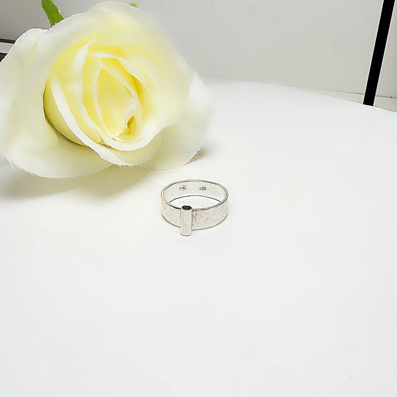 Silver ring with a tube at the front