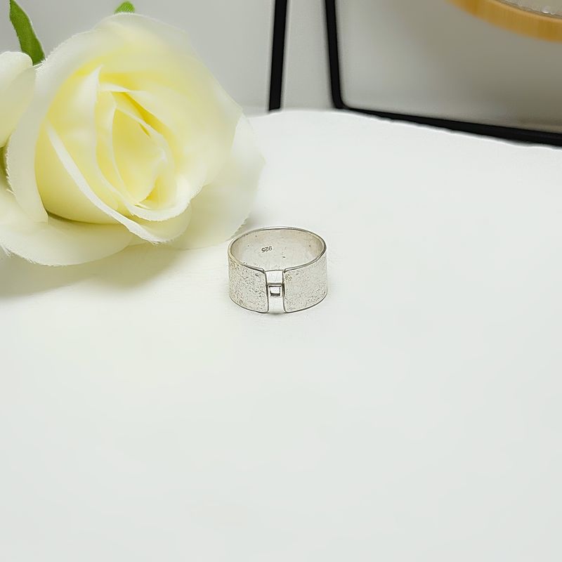Silver wide ring with a small square detail at the front