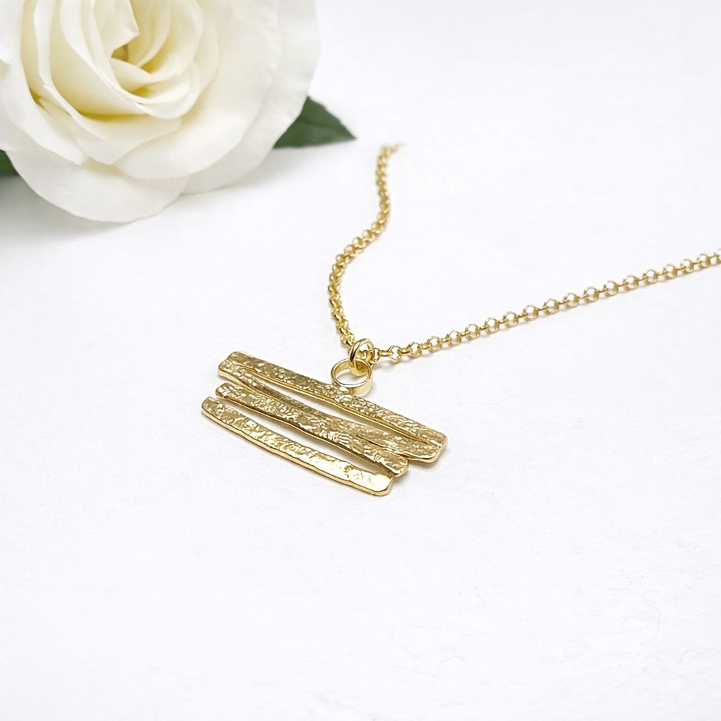 Silver pendant with curved shapes! Available in white or gold-plated silver at Harry TiLLEY.