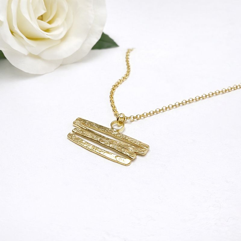 Silver pendant with curved shapes! Available in white or gold-plated silver at Harry TiLLEY.