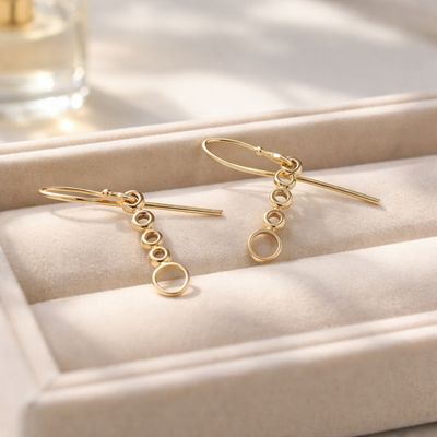 Gold-plated silver round earrings with balls and circles.