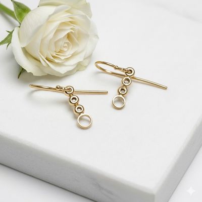 Gold-plated silver round earrings with balls and circles.