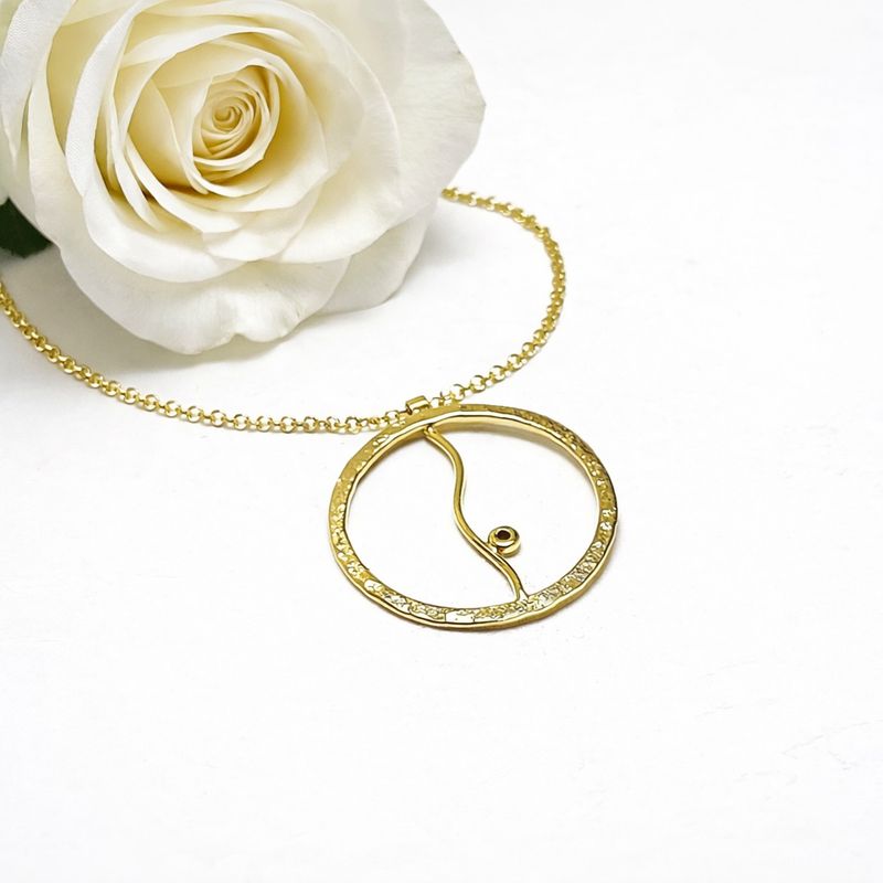 Gold-plated silver circle pendant with wavy detail
