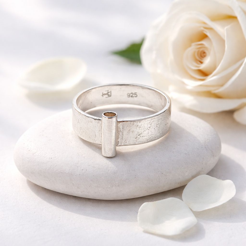 Silver ring with a tube at the front