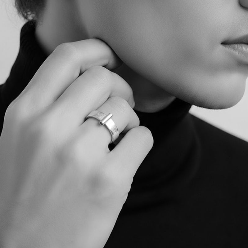 Silver ring with a tube at the front