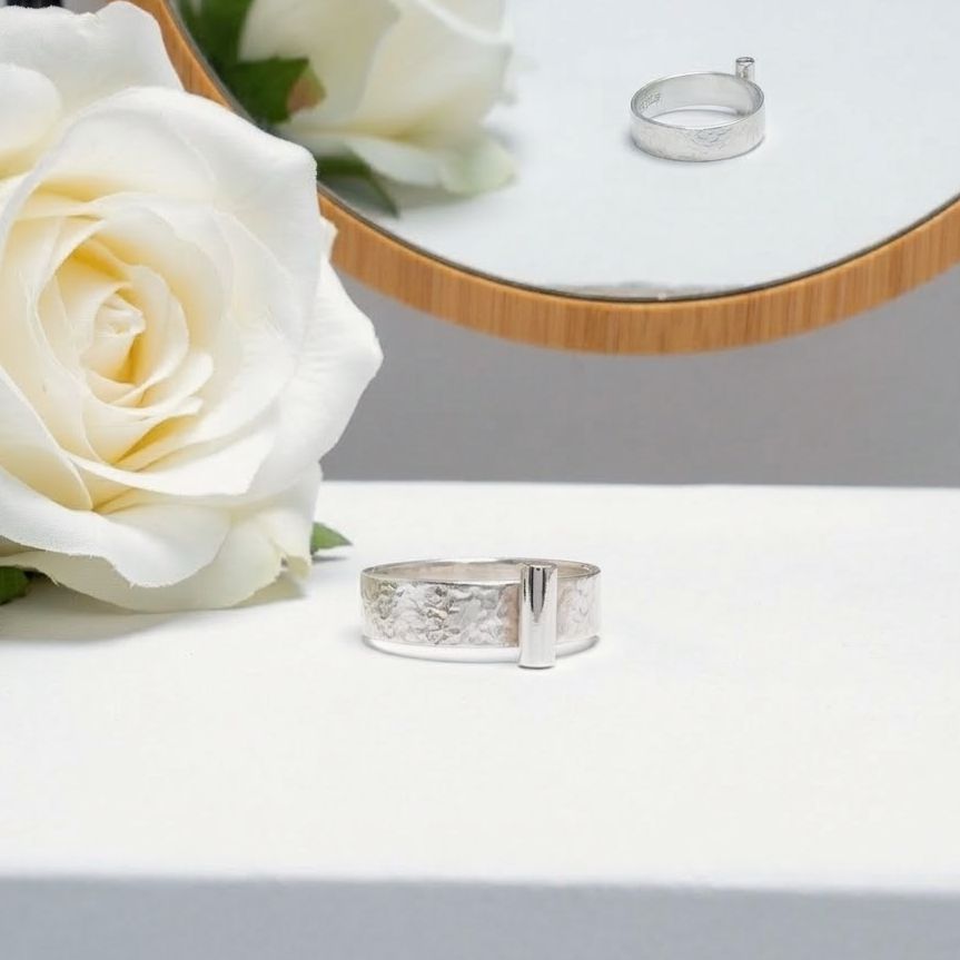 Silver ring with a tube at the front