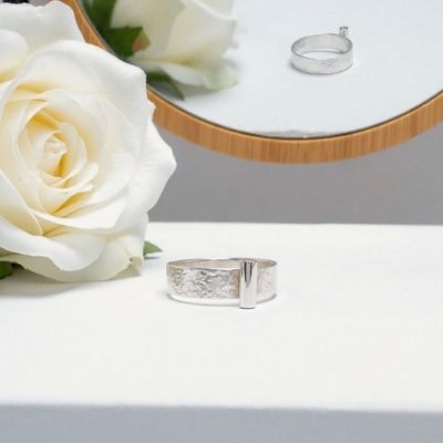 Silver ring with a tube at the front