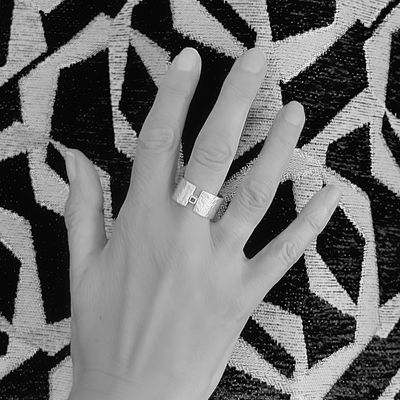 Silver wide ring with a small square detail at the front