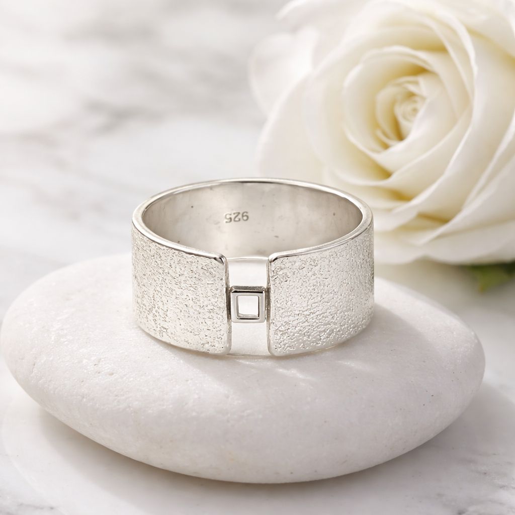Silver wide ring with a small square detail at the front