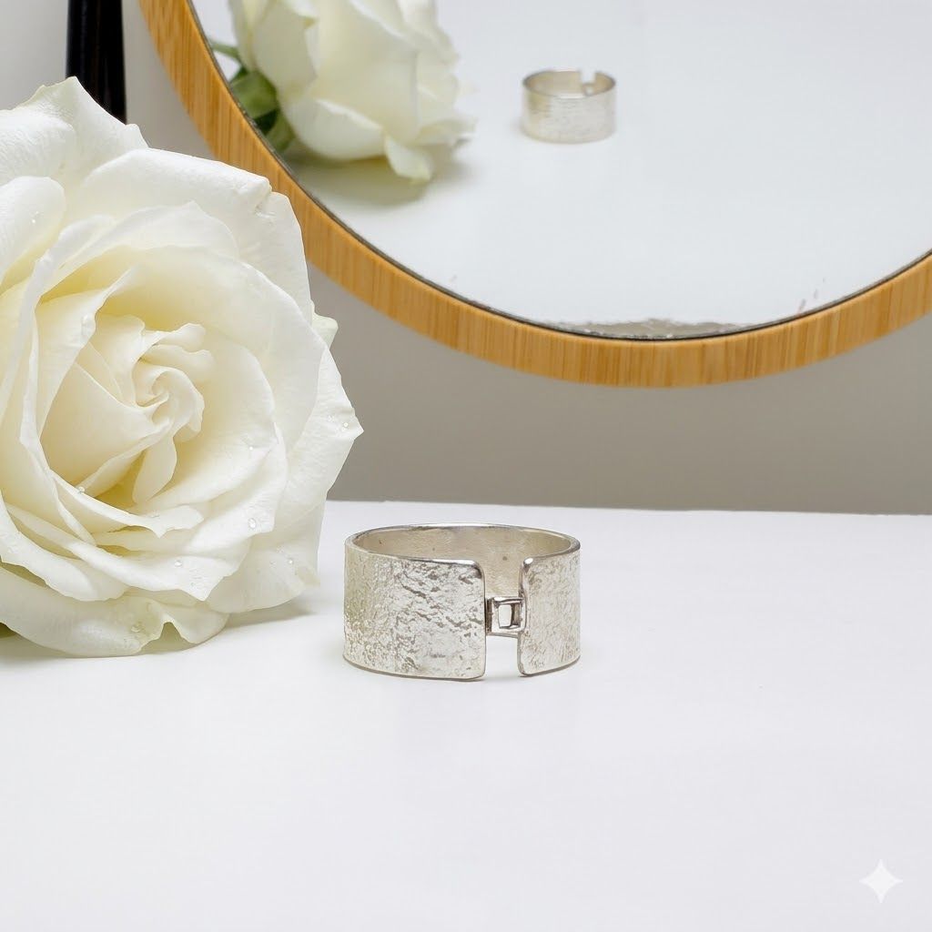 Silver wide ring with a small square detail at the front