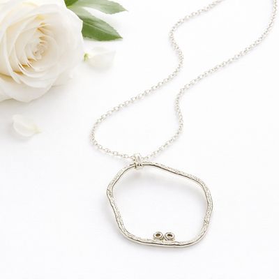 Organic silver pendant with two small eggs