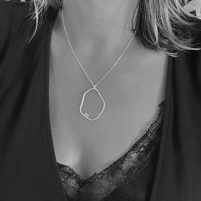 Organic silver pendant with two small eggs