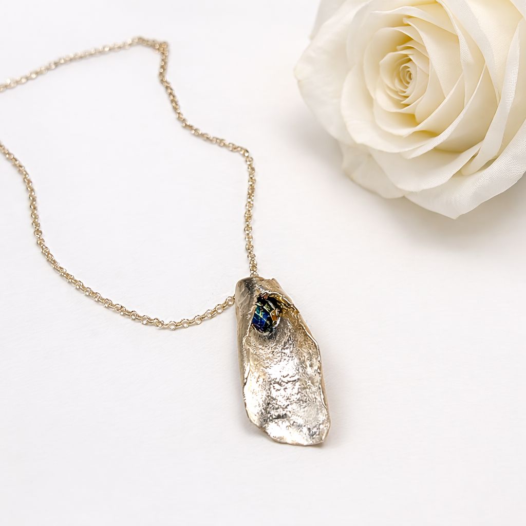 Folded silver pendant with rainbow Swarovski pearls