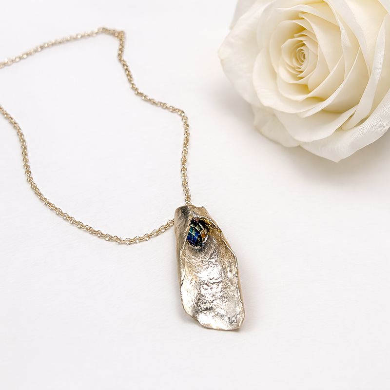 Folded silver pendant with rainbow Swarovski pearls